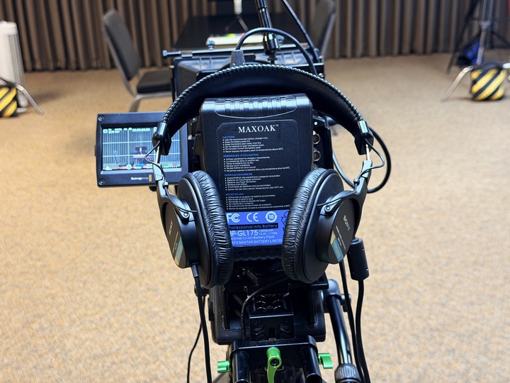 Headphones resting on the rehearsal camera rig