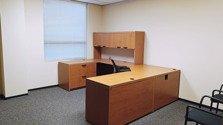 Office 1 desk and cabinetry beside the window