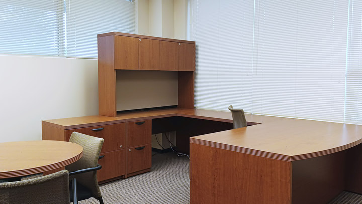 Office 6 desk and round table beside the windows
