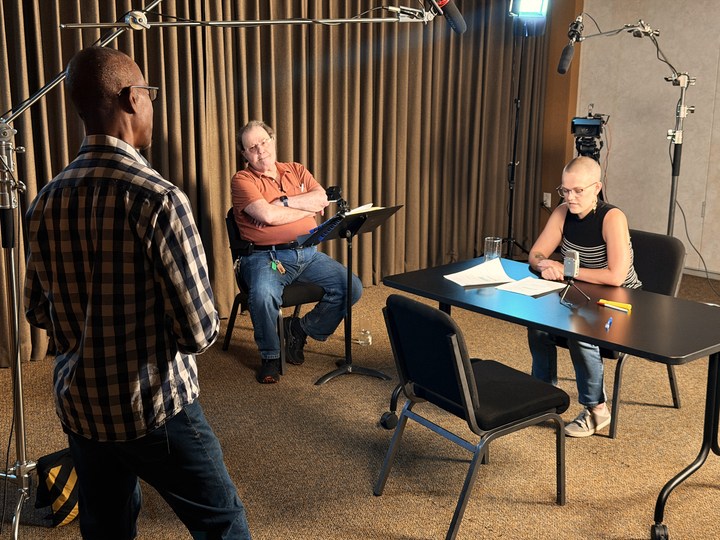 Participants reviewing pages around the rehearsal table