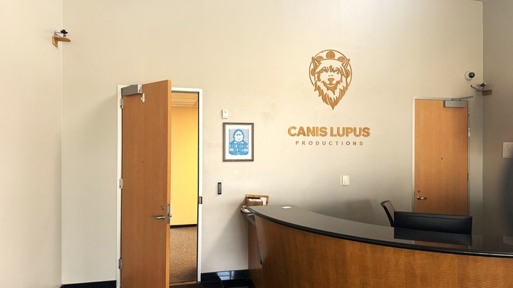 Canis Lupus reception desk beneath the company wall sign