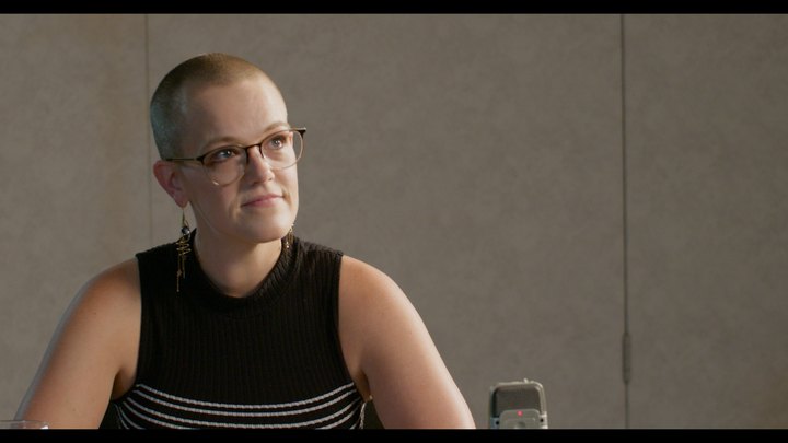 Closer camera view of a seated participant during the Studio 1 table read