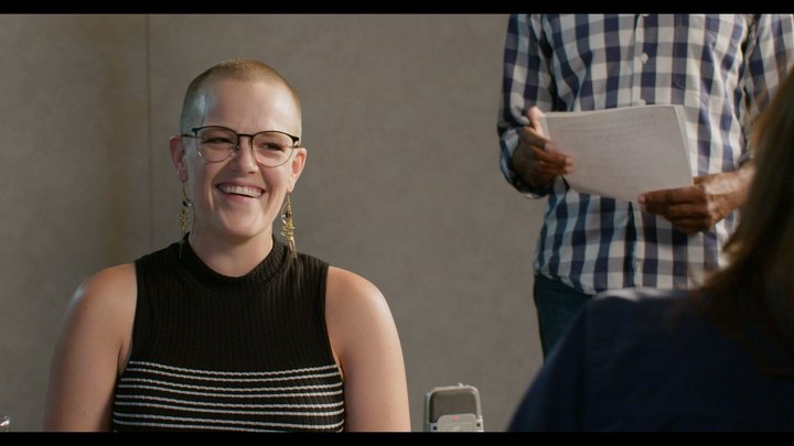 A participant smiling during the Studio 1 table read
